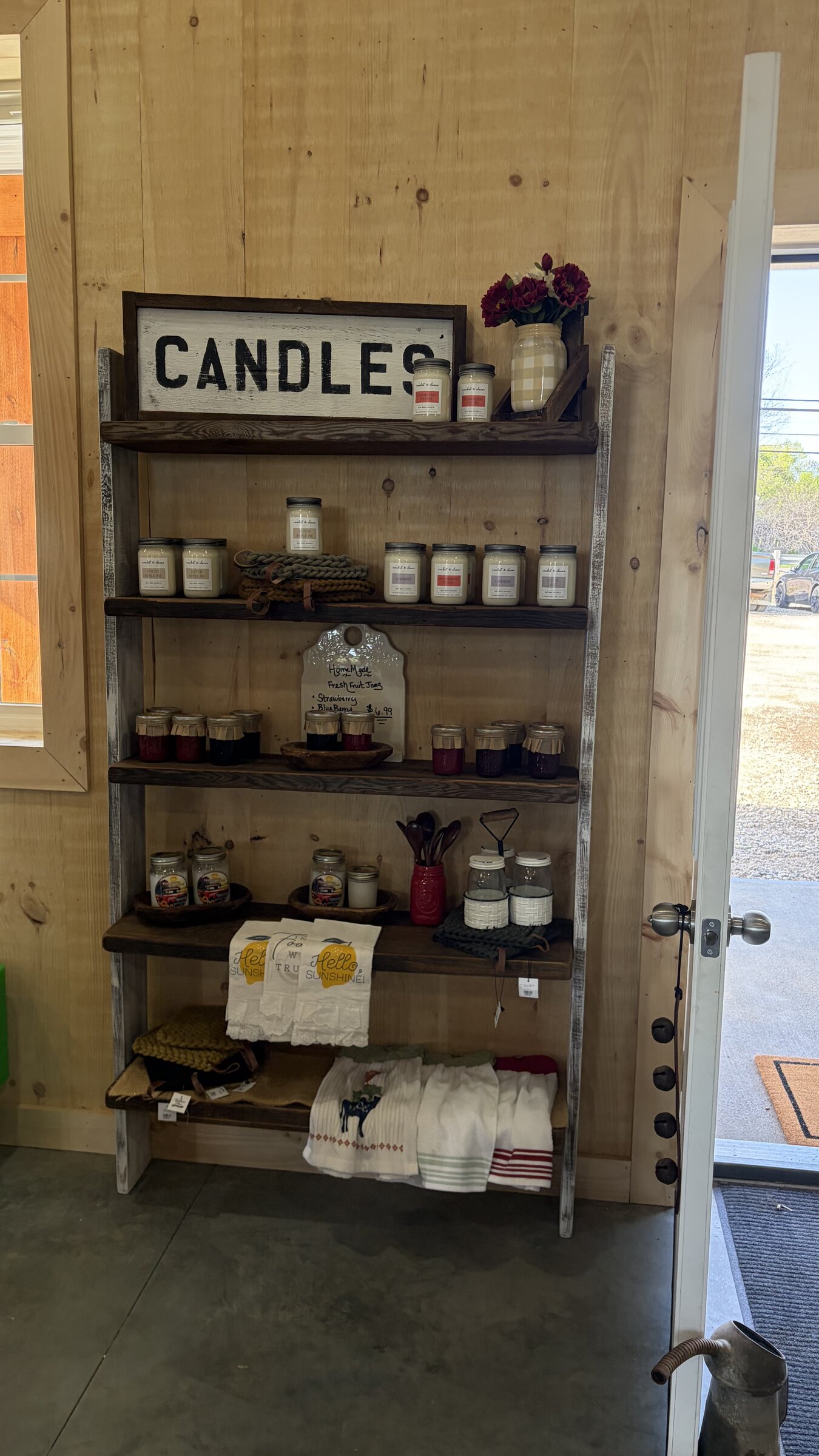 Ladder shelf with candles, homemade jams, and linens