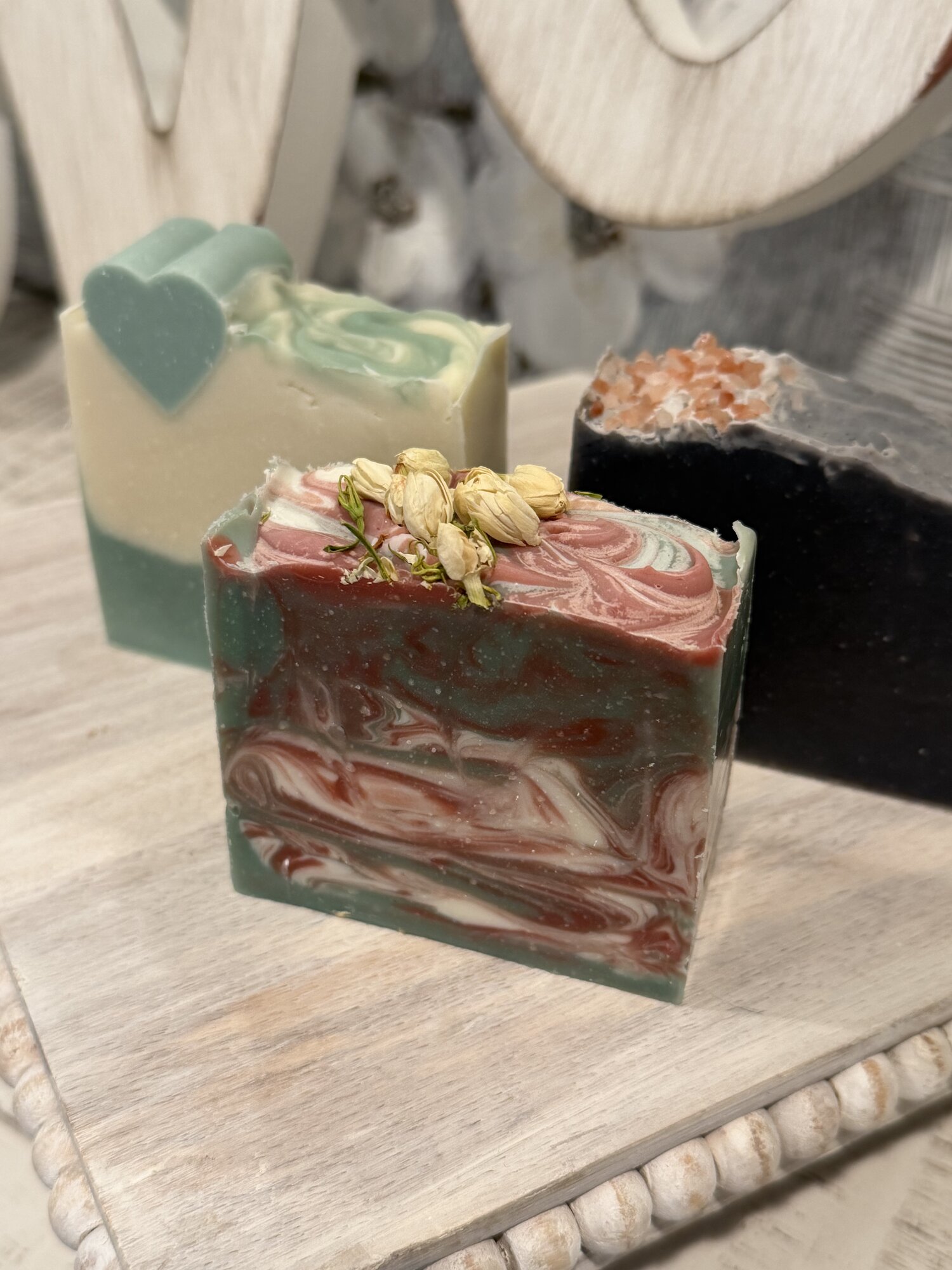 Handmade artisan soaps with floral and salt accents
