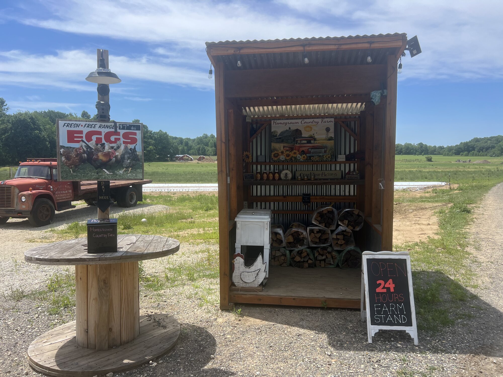 Self-serve 24-hour farm stand with fresh eggs sign